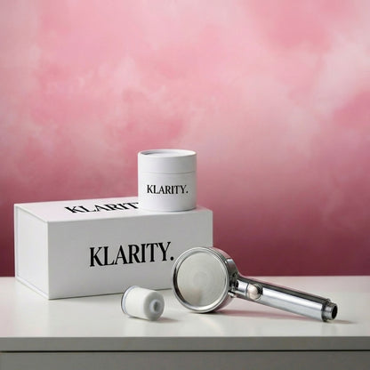 KLARITY shower head and accessories on a pink background